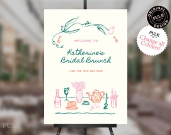 Könnte beinhalten: Ein weißes Schild mit grünen und rosa Illustrationen, das zu einem Braut-Brunch für Katherine am 12. Mai einlädt. Das Schild zeigt ein Blumenmuster, eine Teekanne, Champagner und andere Brunch-Artikel.