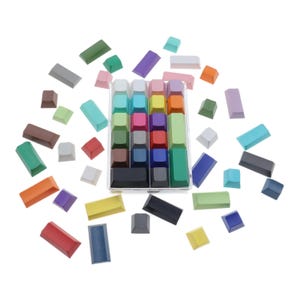 May include: A set of colorful keycaps in a clear plastic case. The keycaps are arranged in a grid pattern and include a variety of colors, including red, blue, green, yellow, and purple.