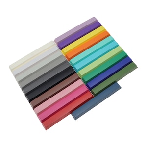 May include: A set of 20 colorful wax crayons arranged in a staggered pattern. The crayons are in various shades of purple, yellow, orange, blue, green, brown, pink, and red.