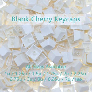May include: A pile of white blank Cherry keycaps. The image shows various sizes, including 1u, 1.25u, 1.5u, 1.75u, 2u, 2.25u, 2.75u, 3u, 6u, 6.25u, 7u, and Iso. The keycaps are made of a smooth, solid material.
