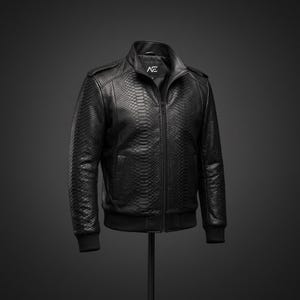 May include: A black jacket featuring a textured snakeskin pattern throughout the exterior. The garment includes a full-length front zipper, a stand-up collar, and ribbed cuffs and hem. A white logo with the letters AE is visible on the inner neck label.
