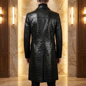 May include: A black, long leather coat with a crocodile skin texture. The coat has a classic design with a notched collar and a button-down front. The coat is knee-length and appears to be well-tailored.