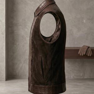 Side profile of a custom motorcycle vest showing the seamless blend of real leather vest textures, deep armholes, and sleek waist pockets.