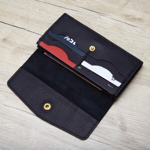 An open black leather wallet with a few credit cards visible inside.