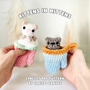 Puede incluir: Dos juguetes de gatitos de ganchillo en mitones. Un gatito es blanco con detalles en rosa, el otro es gris. Los mitones son rosas, azules y naranjas. El texto dice "KITTENS IN MITTENS" y "CROCHET POP PATTERN BY CABLE + CANVAS."