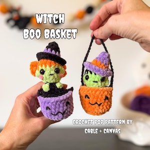 May include: Two small crochet figures in baskets with the text WITCH BOO BASKET and CROCHET POP PATTERN BY CABLE + CANVAS. One figure has orange hair and a black hat in a purple basket, the other has a purple hat in an orange pumpkin basket.