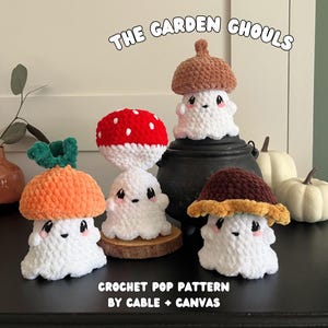 May include: A collection of handmade crochet ghost figures, each with a unique mushroom or acorn cap. The figures are white with black eyes and pink cheeks. The text "THE GARDEN GHOULS" and "CROCHET POP PATTERN BY CABLE + CANVAS" are visible.