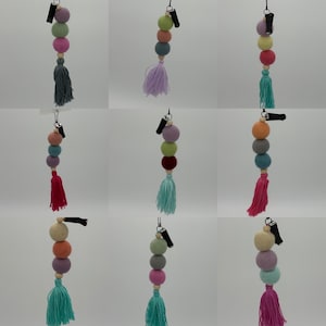 May include: A set of ten colorful felt ball car air fresheners with tassels. Each air freshener has three felt balls and a clip to attach to a car vent.