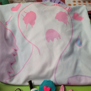 May include: A set of five handmade polymer clay charms featuring a pink and blue ghost, a pink bunny, a green coffin with a pink heart, a pink rose, and a white eye with a black pupil.