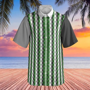 May include: A short-sleeved button-down shirt with a green, white, and black diamond pattern. The shirt has a white collar and a single button closure.