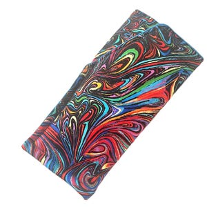 May include: A rectangular glasses case with a vibrant, swirling pattern in shades of red, blue, yellow, and green against a black background. The case is closed and appears to be made of fabric.