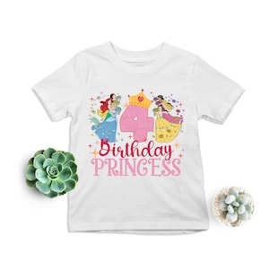 May include: White t-shirt with a pink number four, a crown, and three princesses in colorful dresses. The text "Birthday Princess" is written in pink below the number.