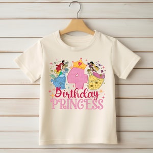 May include: A white t-shirt with a pink number four, a crown, and a graphic of Disney princesses. The text "Birthday Princess" is printed below the graphic.