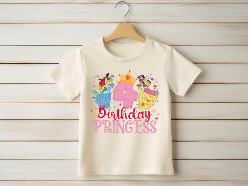 May include: A white t-shirt with a pink number four, a crown, and a graphic of Disney princesses. The text "Birthday Princess" is printed below the graphic.