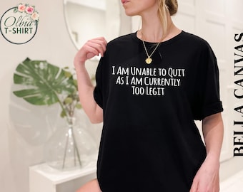 May include: Black t-shirt with white text that reads "I am unable to quit as I am currently too legit".