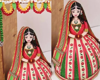 Paper quilled figurine of beautiful woman holding diyas