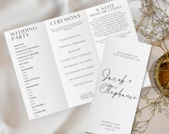 May include: Elegant white wedding program with black text. The program includes sections for the wedding party, ceremony details, and a welcome message. The names Jacob and Stephanie are featured.