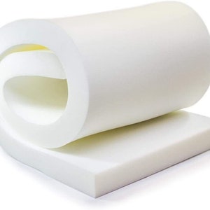 May include: A white foam mattress topper rolled up. The topper is thick and looks comfortable.
