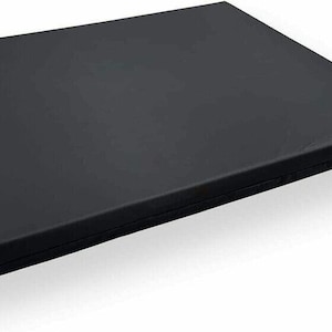 May include: A black rectangular foam mattress pad. The pad is folded in half and has a zipper on one side.