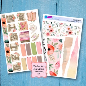 May include: A set of Victorian Gardens themed journaling stickers. The stickers feature floral patterns, teacups, books, and decorative elements. The set includes a sheet of stickers with floral borders, torn paper edges, and a sheet of stickers with various decorative elements.