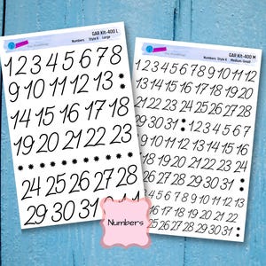 May include: Two sheets of white paper with black numbers printed on them. The numbers range from 1 to 31. The top sheet has the text "GAR Kit-400 L Numbers Style 6 Large" printed on it. The bottom sheet has the text "GAR Kit-400 M Numbers Style 6 Medium-Small" printed on it.
