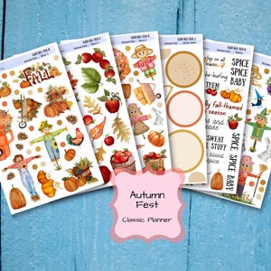 May include: A collection of planner stickers with an autumn theme. The stickers feature pumpkins, scarecrows, apples, and fall foliage. The text "Autumn Fest" and "Classic Planner" are visible. The stickers are arranged on a light blue wooden surface.