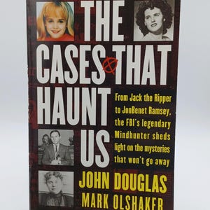 May include: A hardcover book titled "The Cases That Haunt Us" by John Douglas and Mark Olshaker. The cover features images of people and the text "From Jack the Ripper to JonBenet Ramsey". The book is a #1 New York Times bestseller.