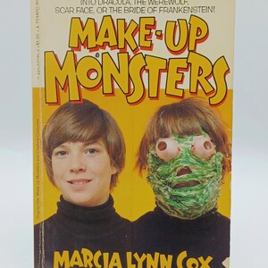 May include: A vintage paperback book, "Make-Up Monsters" by Marcia Lynn Cox. The cover shows two people, one with monster makeup. The book promises instructions for creating monster looks using common ingredients.