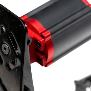 May include: Black metal pedal with a red and black motor attached. The pedal has a cut-out design and the text "Nismo" is visible on the side.