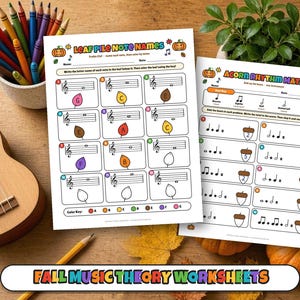 May include: Two educational music theory worksheets titled Leaf Pile Note Names and Acorn Rhythm Math, featuring colorful autumn-themed graphics, musical staves, and math problems, displayed alongside a wooden ukulele, crayons, and pumpkins.