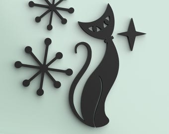 May include: A black wall decal featuring a stylized cat sitting upright with a curved tail, accompanied by two circular starburst shapes and a single four-pointed star. The design is applied to a smooth, light mint green surface.