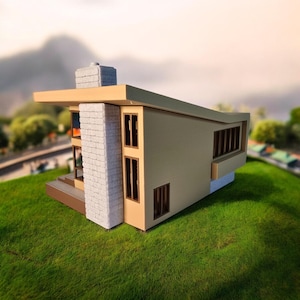 May include: A beige and brown model house with a white brick chimney and several windows. The house is sitting on a green grassy surface.