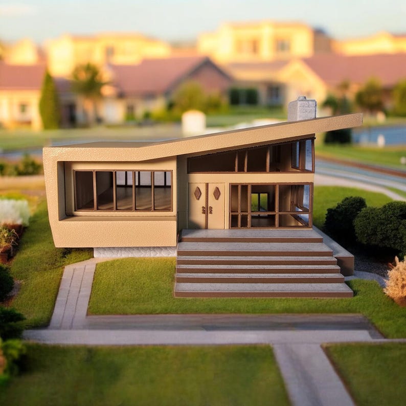 May include: A beige model home with a modern design, featuring a flat roof with a sharp angle, large windows, and a set of stairs leading to the front door.