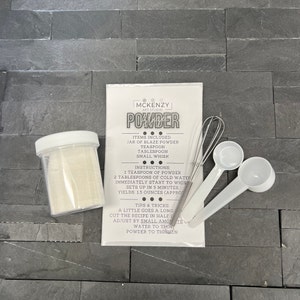 May include: A clear jar of powder with a white lid, a packet with instructions, a small whisk, and two white measuring spoons. The packet reads "MCKENZY ART STUDIO POWDER". The instructions include mixing powder with cold water.