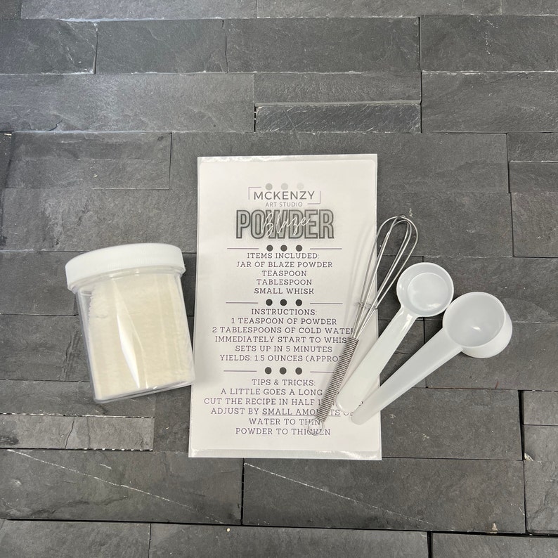 May include: A clear jar of powder with a white lid, a packet with instructions, a small whisk, and two white measuring spoons. The packet reads "MCKENZY ART STUDIO POWDER". The instructions include mixing powder with cold water.