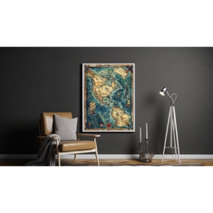 May include: A vintage style map of North America with a compass in the bottom right corner. The map is framed in a white frame and is hanging on a dark gray wall. The map is surrounded by a brown leather chair, a white floor lamp, and two white candlesticks.