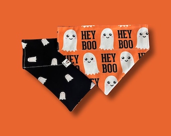 May include: Two dog bandanas, one black with white ghost silhouettes and the other orange with white ghosts and the text "Hey Boo" repeated.