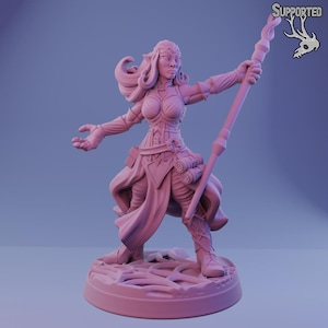 May include: A pink fantasy figurine of a female elf with long hair, wearing a detailed outfit and holding a staff. The figurine is standing on a textured base, with the word "SUPPORTED" and a deer skull logo in the upper right corner.