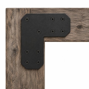 May include: A matte black L-shaped metal corner bracket secured with eight matching black Phillips head screws, attached to the corner of two pieces of weathered, textured brown wood with visible grain and knots.