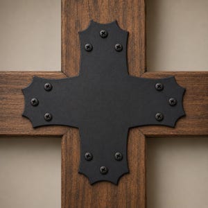 May include: A dark brown wooden cross featuring a central matte black metal plate shaped like a cross with scalloped edges. The metal plate is securely fastened to the wood with ten black screws, each positioned at the points of the plate.