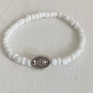 White beaded miraculous medal bracelet