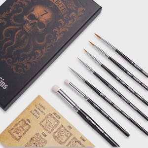 May include: A set of seven black-handled paint brushes with silver ferrules, each labeled with names like Gluttony, Wrath, Greed, Pride, Lust, Envy, and Sloth. The brushes are accompanied by a black box featuring a skull-octopus graphic and a parchment-style card.