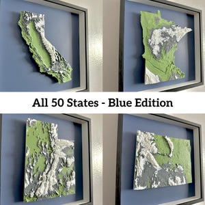 May include: Four framed relief maps of U.S. states, including California, Minnesota, Utah, and an unidentified state. The maps are green, white, and gray, set against a blue background, and framed in black. The text "All 50 States - Blue Edition" is displayed.