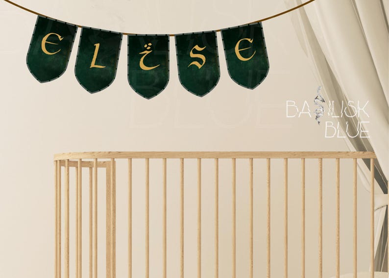 May include: A green and gold banner with the letters "ELISE" in a decorative font. The banner is hanging above a wooden crib.