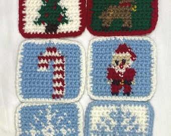 May include: Six square, crocheted Christmas decorations. Each features a different festive design, such as a Christmas tree, Santa Claus, a reindeer, a candy cane, a snowflake, and gifts. The ornaments are in red, white, and blue, with a loop for hanging.