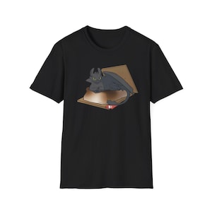 May include: Black t-shirt with a graphic of a black dragon in a s'more. The dragon is sitting in the graham cracker with chocolate and marshmallow.