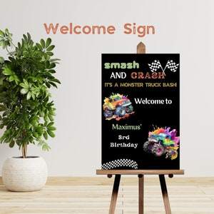 May include: Black welcome sign with a monster truck theme. The sign says "smash and crash it's a monster truck bash!" and "Welcome to Maximus' 3rd Birthday".