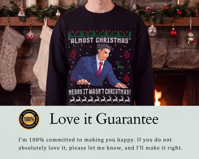 May include: A black long-sleeve sweatshirt featuring a graphic of a character in a blue suit and red tie. The text reads "ALMOST CHRISTMAS" and "MEANS IT WASN'T CHRISTMAS!" surrounded by green and red holiday patterns including reindeer and ornaments.
