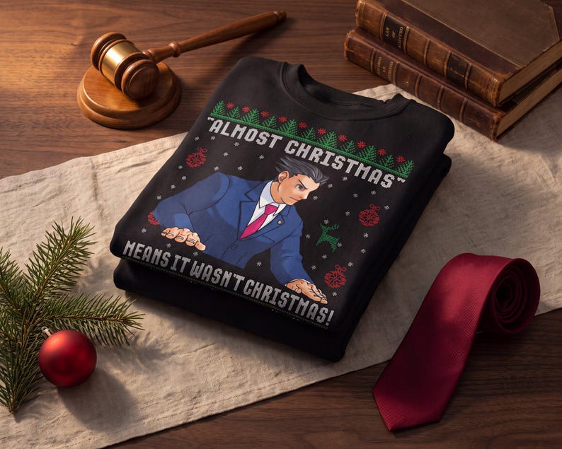 May include: A black crewneck sweatshirt featuring a graphic of a character in a blue suit and red tie pointing forward. The text reads "ALMOST CHRISTMAS" and "MEANS IT WASN'T CHRISTMAS!" surrounded by green pine trees, red ornaments, and snowflakes.