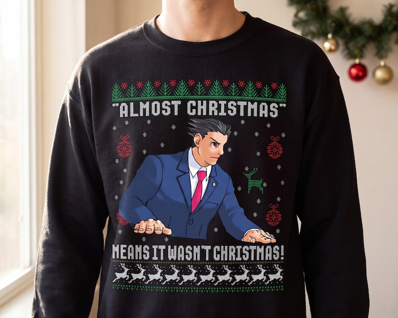 May include: A black crewneck sweatshirt featuring a graphic of a character in a blue suit and pink tie. The text reads "ALMOST CHRISTMAS" and "MEANS IT WASN'T CHRISTMAS!" surrounded by green pine trees, red ornaments, and white reindeer patterns.